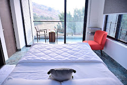 Spacious bedroom with hill views through large windows